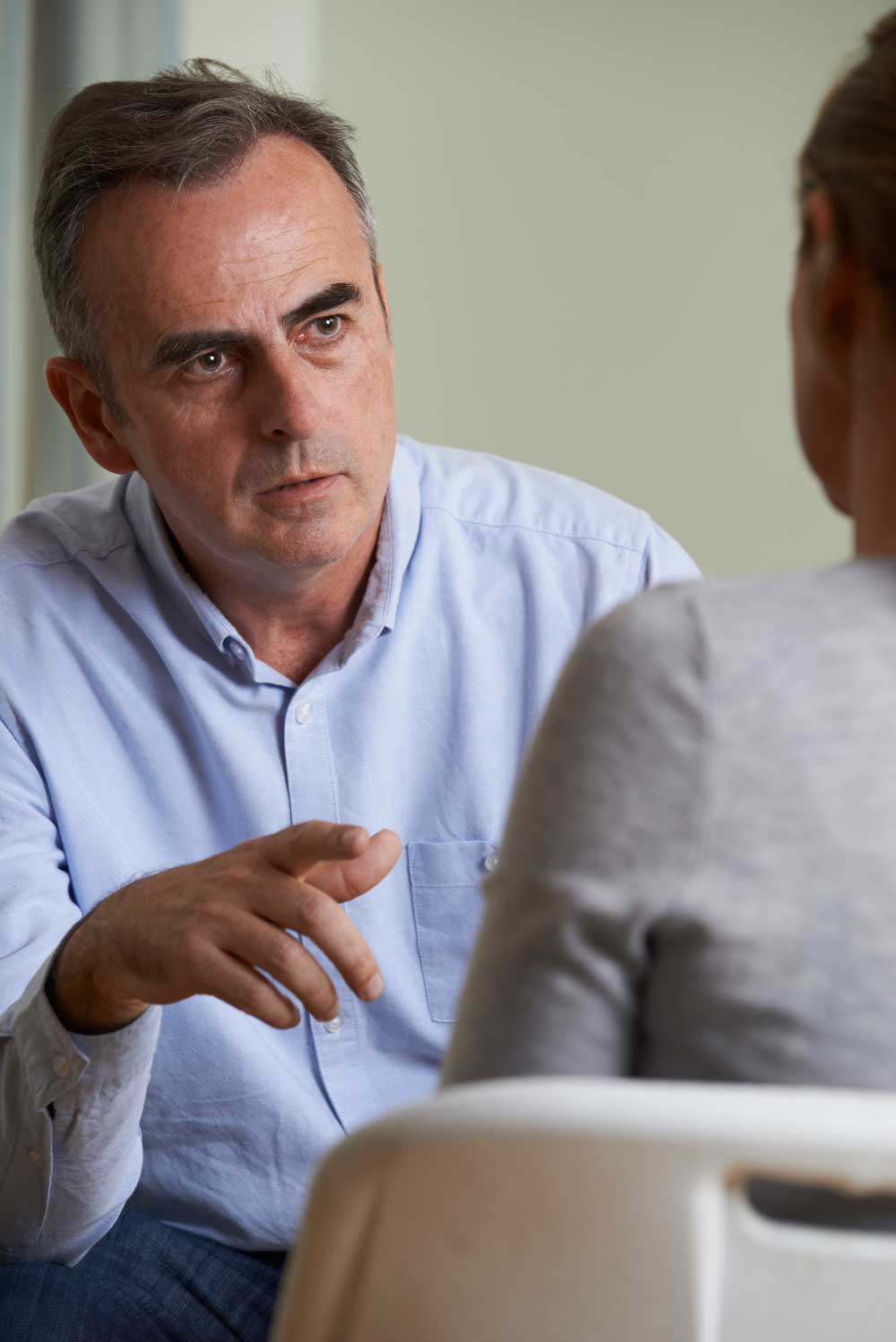 A Depressed Man Speaking With Counselor