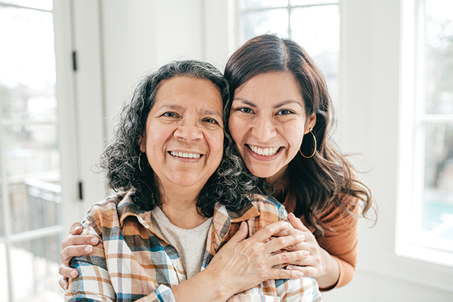 Younger woman holding older woman